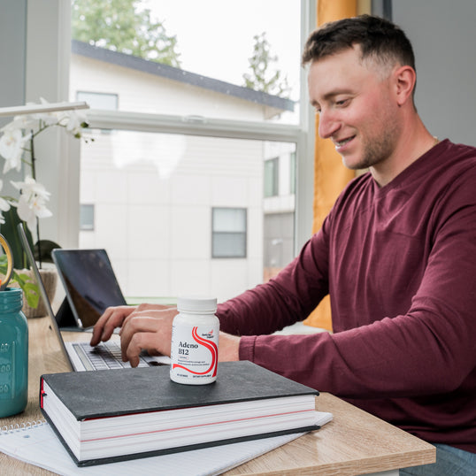 image of man sitting at desk on computer