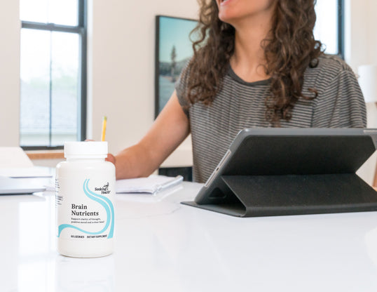 Brain Nutrients on a counter in front of a woman