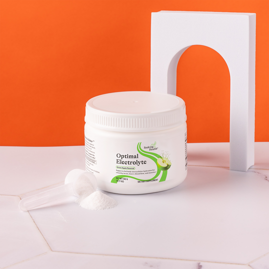 Container of 'Optimal Electrolyte' on a light surface with an orange background