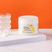 Jar of 'Optimal Electrolyte' supplement on a white surface with an orange background | Lemonade / 1 Pack, Lemonade / 3 Pack, Lemonade / 6 Pack