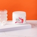 Container of 'Optimal Electrolyte' on a white surface with an orange  background | Strawberry Watermelon / 1 Pack, Strawberry Watermelon / 3 Pack, Strawberry Watermelon / 6 Pack