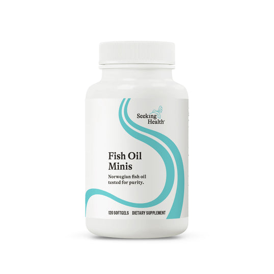 A white plastic bottle of Seeking Health Fish Oil Minis dietary supplement, featuring a white label with teal wavy lines and black text, set against a plain white background.