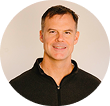 Person wearing a black jacket on a plain background