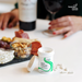 DAO Enzyme supplement bottle on a table with snacks and people in the background