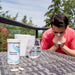 A man sneezing next to a bottle of Histamine Nutrients