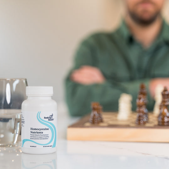 Image of man playing chess at table