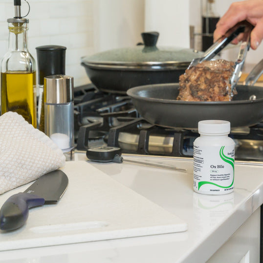 Image of person cooking a steak on the stove
