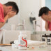 A man washing his face behind a bottle of Skin Nutrients