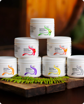 Stack of Optima Electrolyte containers on a wooden surface with a blurred background